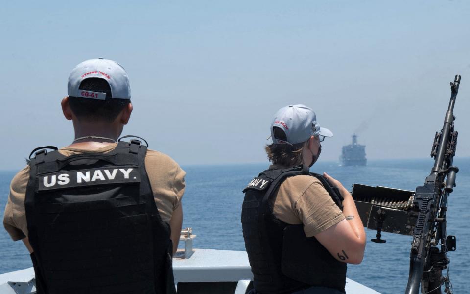 US Navy personnel aboard the guided-missile cruiser USS Monterey (CG 61) looking on while the vessel transits through the Strait of Hormuz. - - Chelsea Palmer/Chelsea Palmer