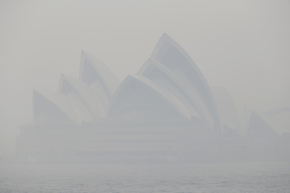 Thick smoke from wildfires shroud the Opera House in Sydney, Australia, Tuesday, Dec. 10, 2019. Hot dry conditions have brought an early start to the fire season. (AP Photo/Rick Rycroft)