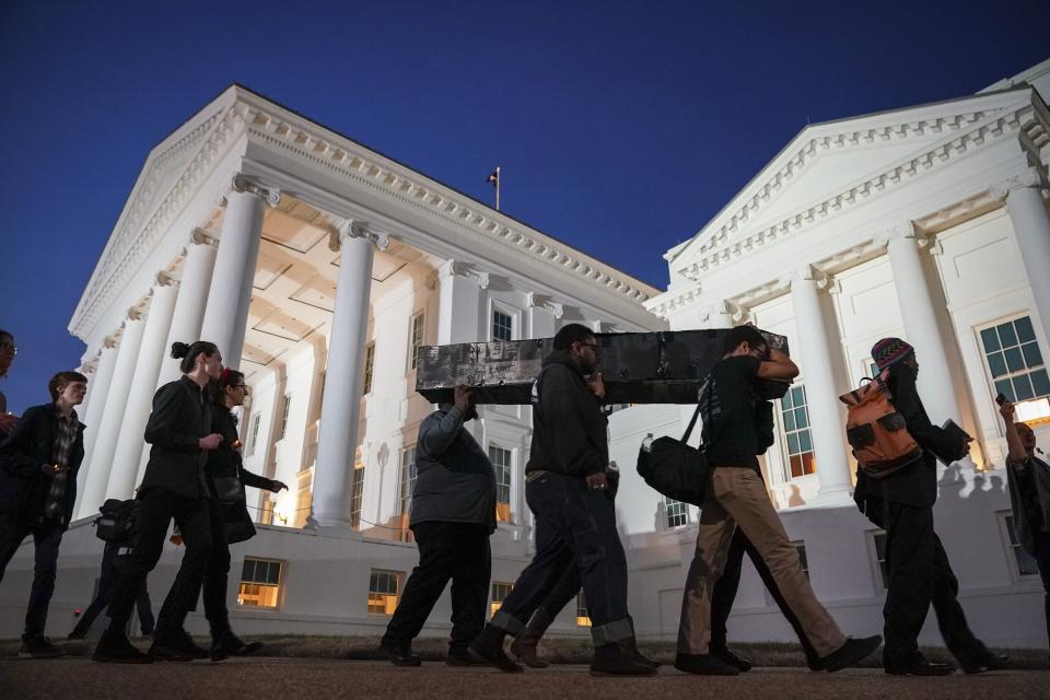 Protestors carry a fake coffin, to symbolize what they call the death of the Democratic Party, toward the Virginia State Capitol, February 7, 2019 in Richmond, Virginia. Virginia state politics are in a state of upheaval, with Governor Ralph Northam and State Attorney General Mark Herring both admitting to past uses of blackface and Lt. Governor Justin Fairfax accused of sexual misconduct.