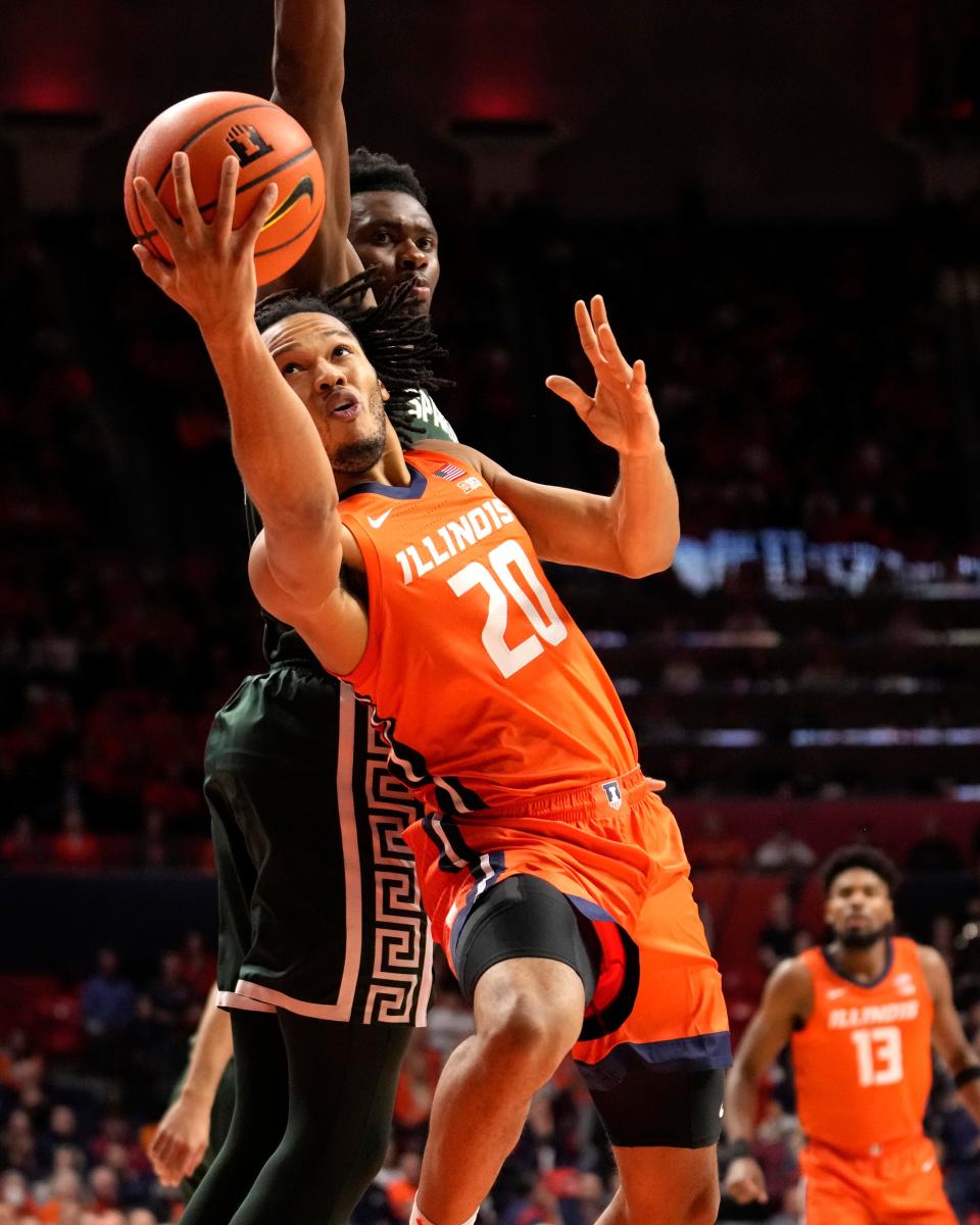 Illinois' Ty Rodgers drives to the basket past Michigan State's Mady Sissoko during the first half at State Farm Arena in Champaign, Illinois, on Thursday, Jan. 11, 2024.