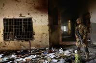 A Pakistani soldier inspects one of the classrooms after the 2014 attack by Taliban militants on an army-run school in Peshawar