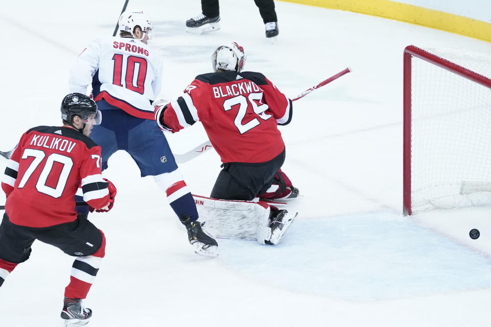 Washington Capitals right wing Daniel Sprong (10) skates against New Jersey Devils goaltender Mackenzie Blackwood (29) during the first period of an NHL hockey game, Saturday, Feb. 27, 2021, in Newark, N.J. (AP Photo/Mary Altaffer)