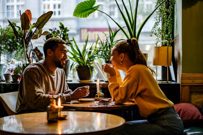 Two people enjoying a meal together in a cozy restaurant setting