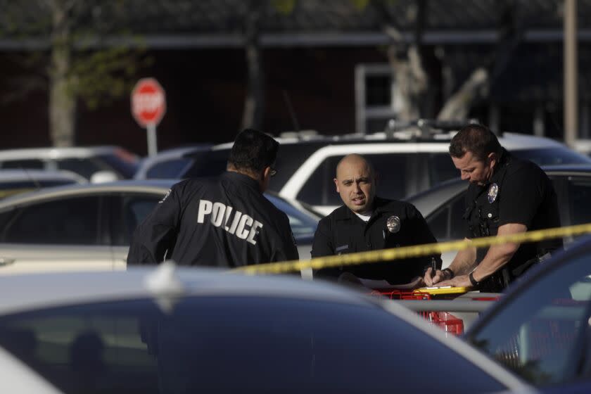 WEST HILLS, CA - APRIL 1, 2023 - Police investigate the scene of a shooting in a West Hills shopping parking lot that left one person dead and many others wounded at 6751 Fallbrook Avenue in West Hills on April 1, 2023. (Genaro Molina / Los Angeles Times)