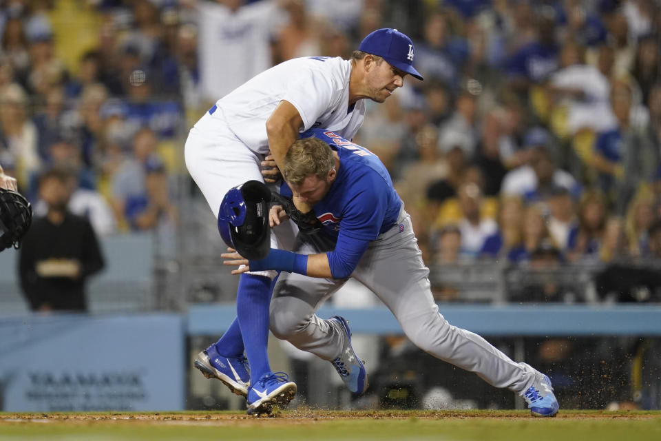 Los Angeles Dodgers starting pitcher Tyler Anderson, left, tags out Chicago Cubs' Ian Happ at home during the sixth inning of a baseball game in Los Angeles, Friday, July 8, 2022. (AP Photo/Ashley Landis)