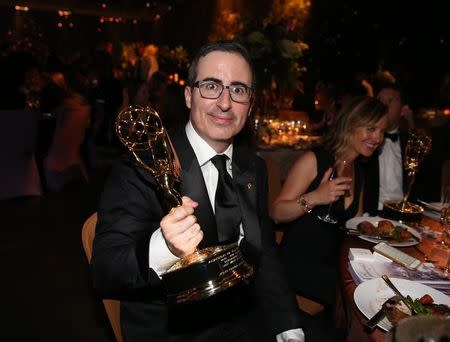 John Oliver holds his award for Outstanding Variety Talk Series for "Last Week Tonight With John Oliver" at the Governors Ball after the 68th Primetime Emmy Awards in Los Angeles, California U.S., September 18, 2016. REUTERS/Lucy Nicholson