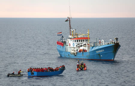 FILE PHOTO: Migrants on a wooden boat are rescued by the crew of the German NGO Jugend Rettet ship "Juventa" in the Mediterranean sea off the Libyan coast, June 18, 2017. REUTERS/Stefano Rellandini/File Photo