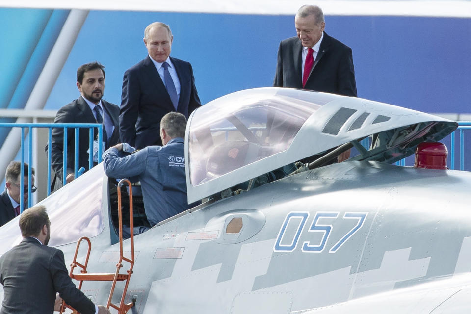 Russian President Vladimir Putin, center, and Turkish President Recep Tayyip Erdogan, right, inspect Sukhoi Su-57 fifth-generation fighter during the MAKS-2019 International Aviation and Space Show in Zhukovsky, outside Moscow, Russia, Tuesday, Aug. 27, 2019. Turkish President is on a short working visit in Russia. (AP Photo/Pavel Golovkin)