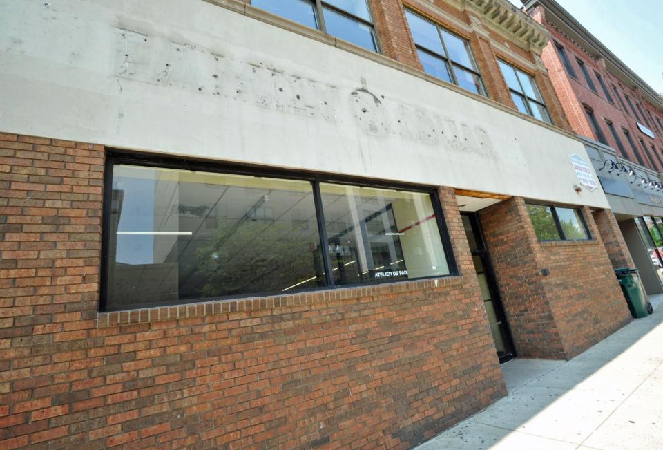 The outline of the the now closed Family Dollar store lettering remains above the entrance on this building of several stores on Hancock Street in downtown Quincy that will be razed to make way for an apartment building, Wednesday, July 12, 2023.