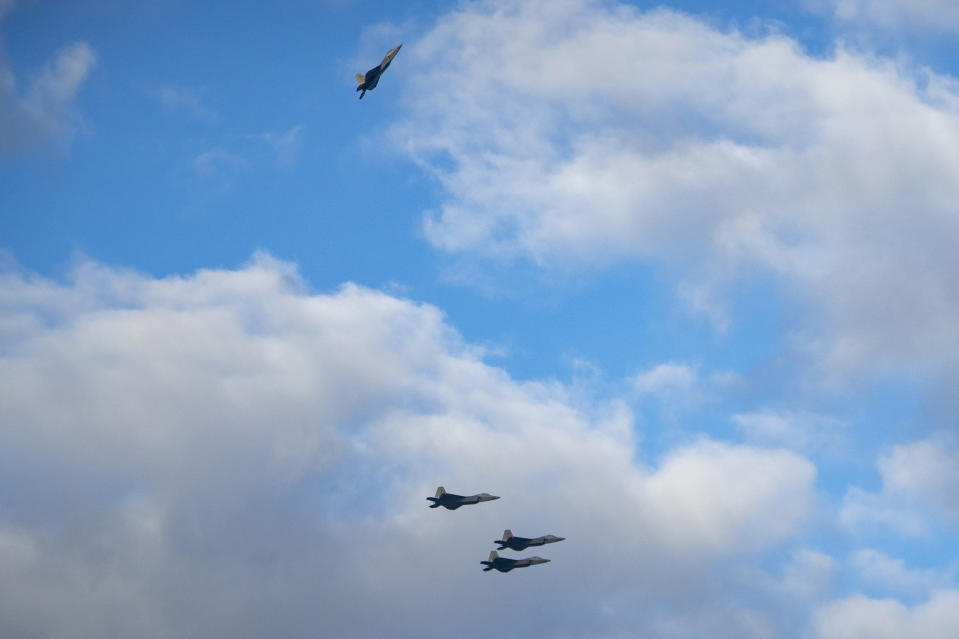F22 Raptors execute the missing man formation during the 82nd Pearl Harbor Remembrance Day ceremony on Thursday, Dec. 7, 2023, at Pearl Harbor in Honolulu, Hawaii. (AP Photo/Mengshin Lin)