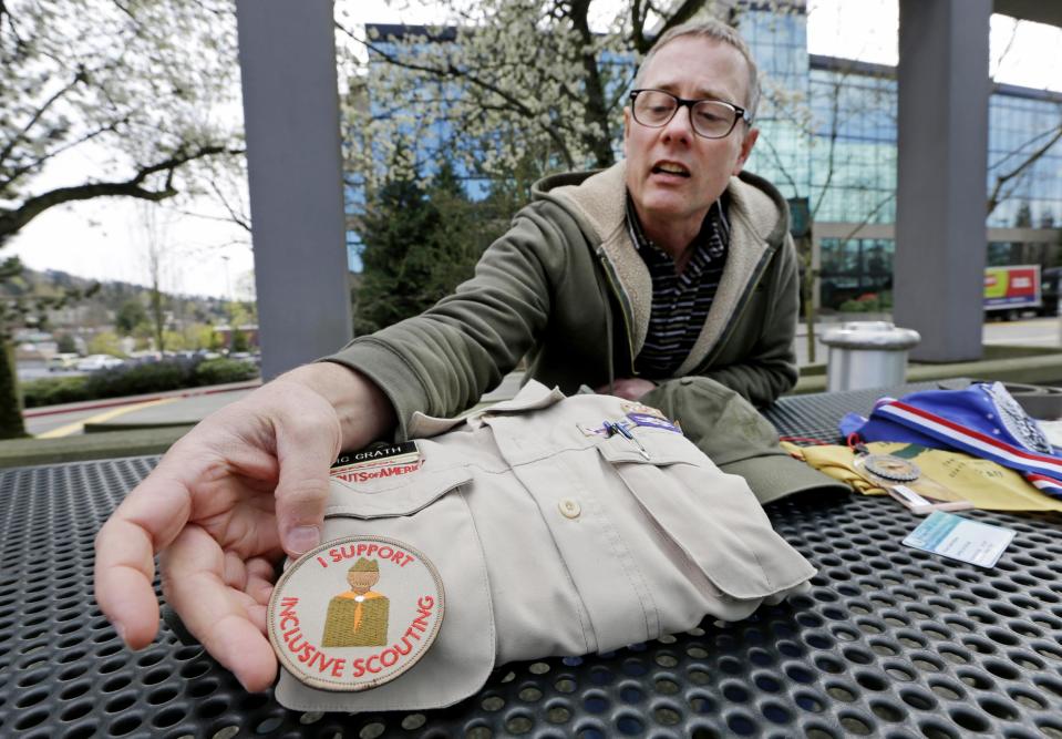 Geoff McGrath points out an "inclusive scouting" badge worn on his Boy Scout scoutmaster uniform shirt for the Seattle troop he led, Tuesday, April 1, 2014, in Bellevue, Wash. The Boys Scouts of America has removed McGrath, an openly gay troop leader, after saying he made an issue out of his sexual orientation. The BSA told McGrath in a letter Monday that “it has no choice but to revoke your registration” after he told news media he was gay in connection with a news story. McGrath, who earned the rank of Eagle Scout, has been leading Seattle Troop 98 since its application was approved last fall. (AP Photo/Elaine Thompson)