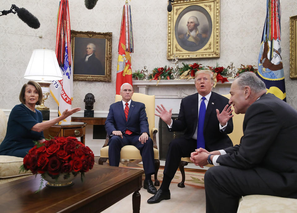 U.S. President Donald Trump (2R) argues about border security with Senate Minority Leader Chuck Schumer (D-NY) (R) and House Minority Leader Nancy Pelosi (D-CA) as Vice President Mike Pence sits nearby in the Oval Office on December 11, 2018 in Washington, DC. (Photo by Mark Wilson/Getty Images)