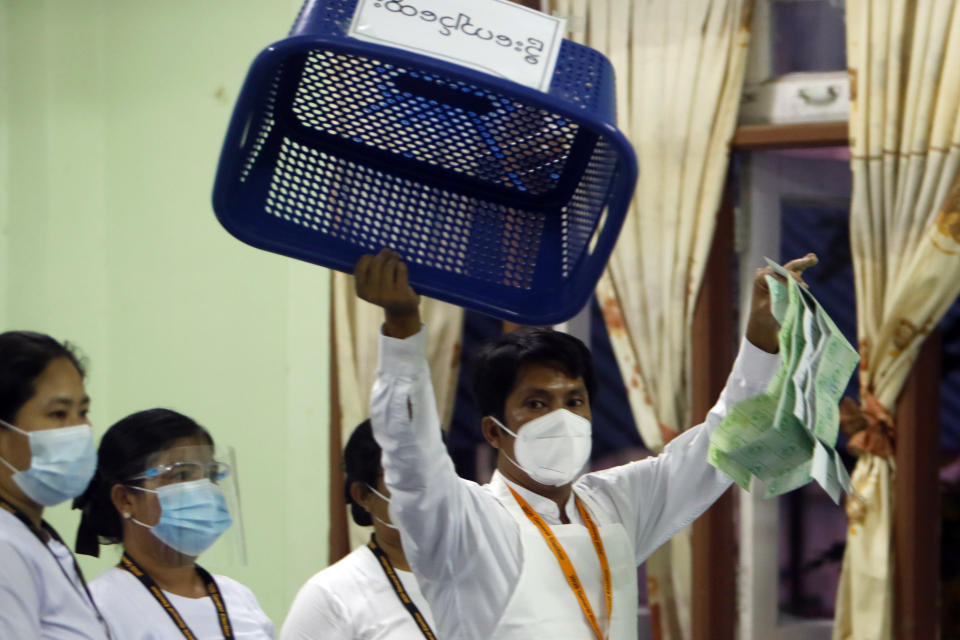 An official of the Union Election Commission shows off an empty box as they prepare to count ballots at a polling station Sunday, Nov. 8, 2020, in Naypyitaw, Myanmar. Voters in Yangon turned up early Sunday in large numbers to vote in nationwide elections that are expected to return to power the party of Nobel Peace Prize laureate Aung San Suu Kyi. (AP Photo/Aung Shine Oo)