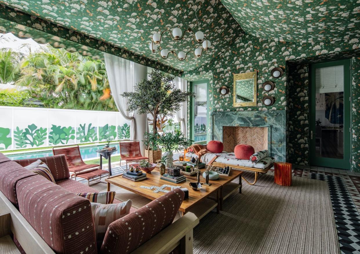 a living room with a large chandelier and a table