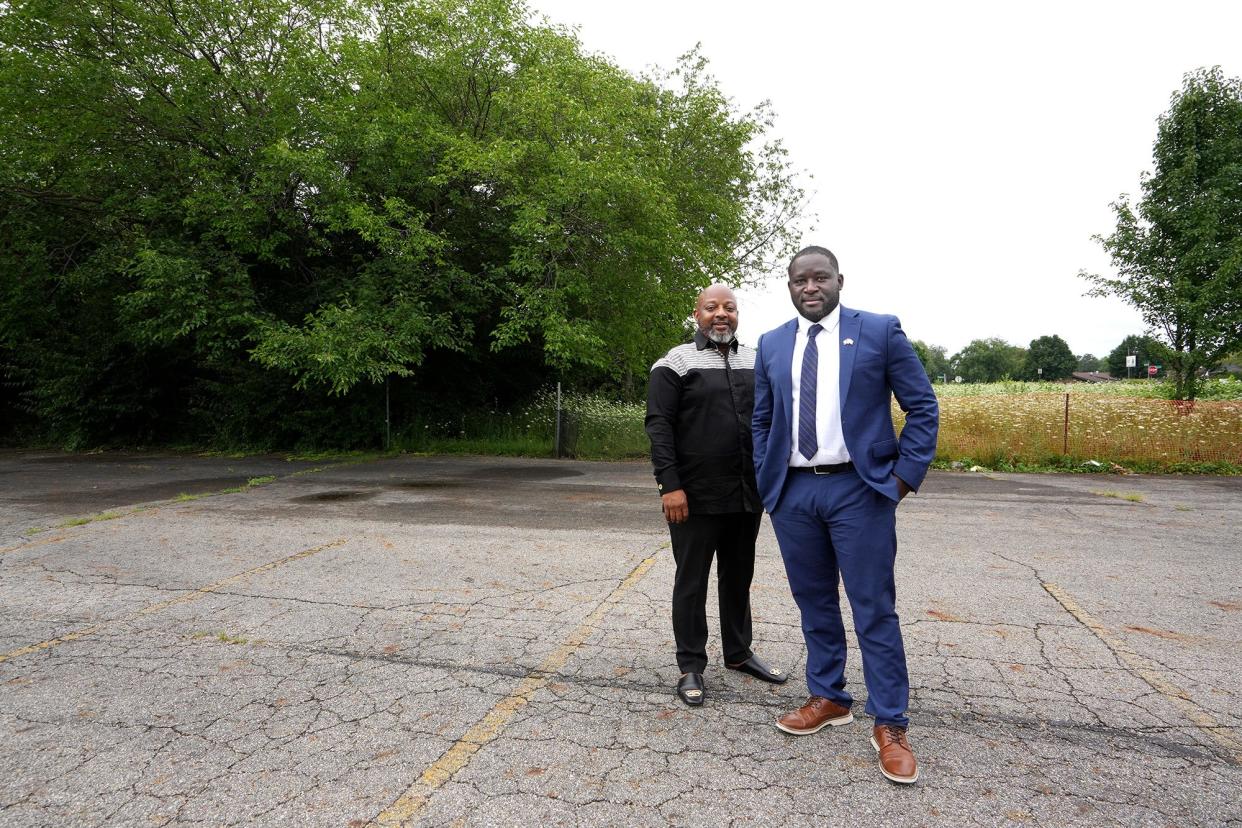 Hale Harmon, left, chairman of the board of Liberians in Columbus, Inc., visits the site of a proposed community center with the nonprofit's executive director, Alpha Tongor. The group aims to build a 14,000-square-foot community center on an acre of land in the Eastland neighborhood.