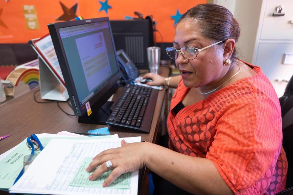 Saira Olivo, family engagement specialist, makes calls to parents of absentee students Tuesday, Sept. 27, 2022, at Cesar Chavez Elementary School in Fort Worth. Olivo helps families get support services to ensure they are successful.