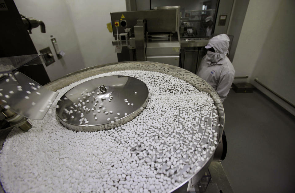 FILE - In this file photo taken Thursday, Feb. 9, 2012, a pharmacist works in a lab where medicines are being produced at a manufacturing unit on the outskirts of Mumbai, India. India's patent office on Monday March 12, 2012 effectively ended Bayer's monopoly on a patented cancer drug by allowing the manufacturing of a generic copy at a fraction of the price. (AP Photo/Rafiq Maqbool, File)