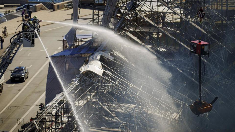 Firefighters spray water on the Old Stock Exchange in Copenhagen