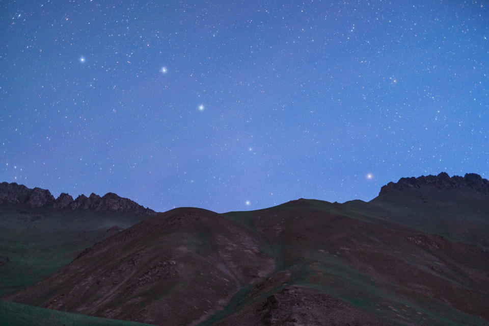 a dark blue sky filled with stars and the distinct asterism of the big dipper.