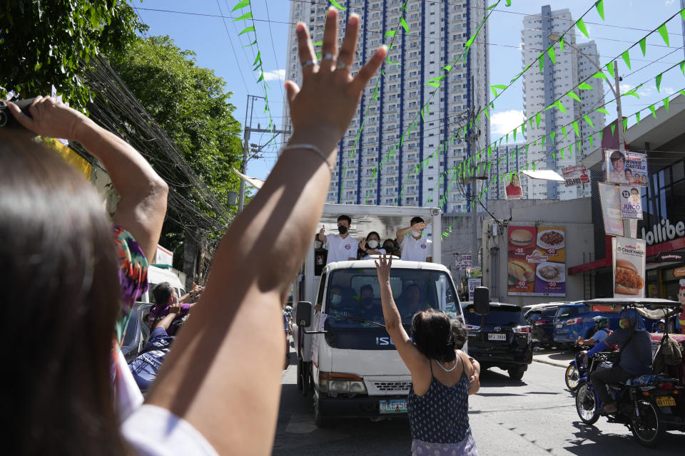 Residents wave to Quezon City Mayor Joy Belmonte, center, during a motorcade as she starts her re-election campaign in Quezon City, Philippines on Friday, March 25, 2022. Candidates for thousands of provincial, town and congressional posts started campaigning across the Philippines Friday under tight police watch due to a history of violent rivalries and to enforce a lingering pandemic ban on handshakes, hugging and tightly packed crowds that are a hallmark of often circus-like campaigns. (AP Photo/Aaron Favila)