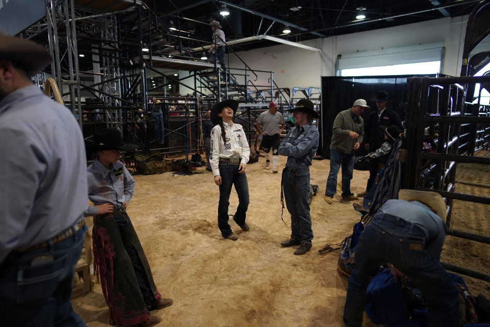 Najiah Knight laughs while waiting to compete in the bull riding competition during the Junior World Finals rodeo, Thursday, Dec. 7, 2023, in Las Vegas. Najiah, a high school junior from small-town Oregon, is on a yearslong quest to become the first woman to compete at the top level of the Professional Bull Riders tour. (AP Photo/John Locher)