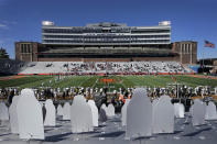 Cardboard cutouts of Illinois football fans are erected in the east seats of Memorial Stadium as family members of both Illinois and Purdue players occupy the west seats during the first half of an NCAA college football game Saturday, Oct. 31, 2020, in Champaign, Ill. (AP Photo/Charles Rex Arbogast)