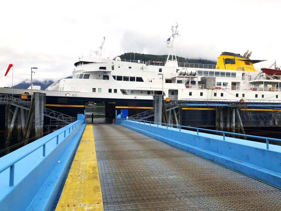 A ferry ship as viewed by the platform to enter it.