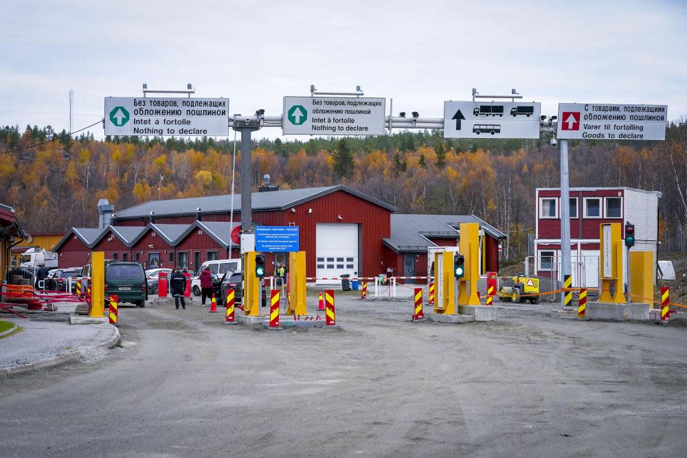 Yellow gates and low-rise buildings at a vehicle checkpoint