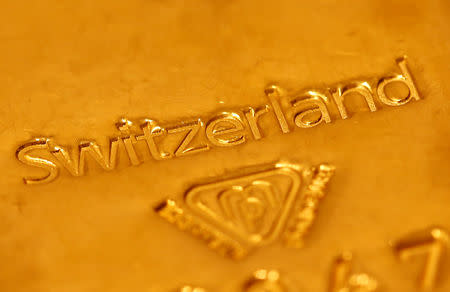 FILE PHOTO: A one kilogramm gold bar imprinted with the word 'Switzerland' is displayed in a Swiss bank in Bern November 25, 2014. Picture taken November 25, 2014. REUTERS/Ruben Sprich