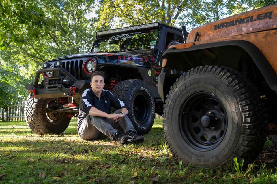 Melissa Dinkins of Laingsburg sits with her 2002 Jeep Wrangler Sport that she has had for 10 years at her home in Laingsburg on September 17, 2020. 
Dinkins, who started the 1,500 member all women club called Michigan Jeep Ladies four years ago, named the Jeep Stevie for her admiration of the singer Stevie Nicks. The group does multiple events a year but was slowed down by complications due to COVID. "There was nothing in the state of Michigan that was geared towards women and there's a lot of women in the Jeep community. A lot of them are pretty bad ass," Dinkins said, who like other members of her club build their own rigs and do their own repairs.