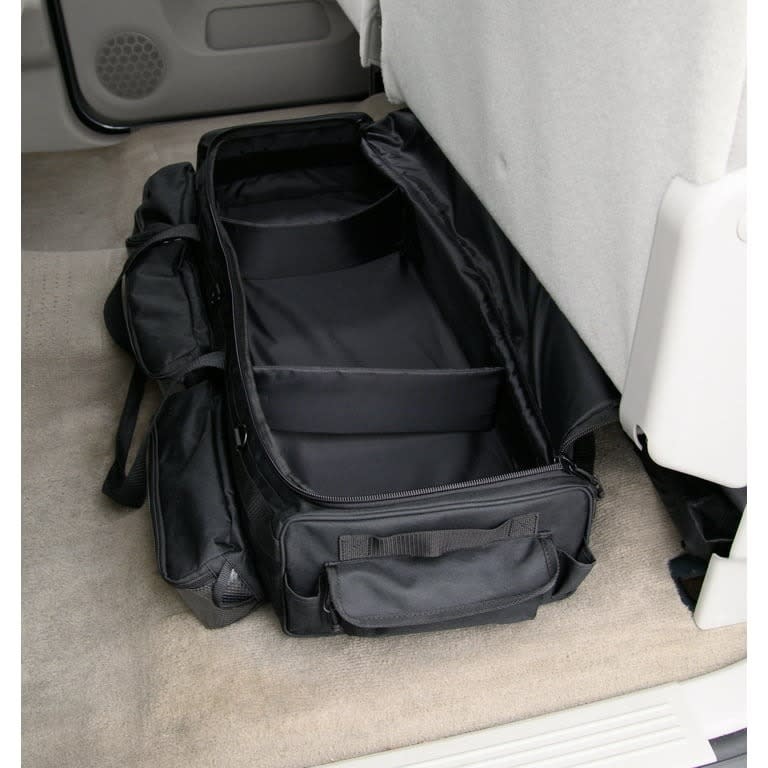 An under the seat organizer on a car floor