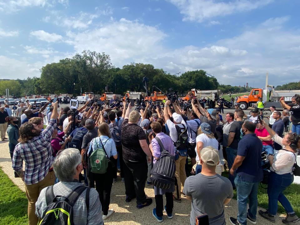 Journalists surround a protester and counter-protester at a rally in support of January 6 detainees on Saturday. (Richard Hall / The Independent )