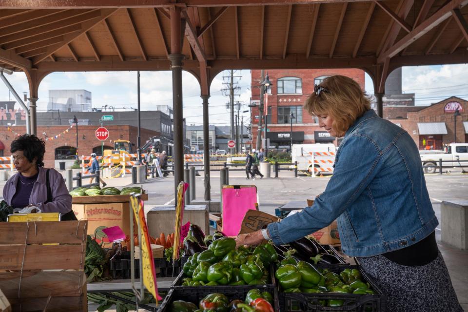 Debby Greene, 68, of Rogers City, shops for produce in Eastern Market on Tuesday, Sept. 19, 2023, near the historic building that partially collapsed in Eastern Market on Saturday, Sept. 16, 2023.