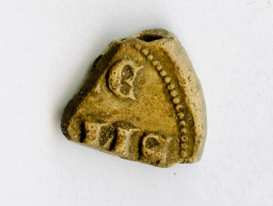 One side of the 650-year-old papal bulla, or lead seal, found by Jacek Ukowski.