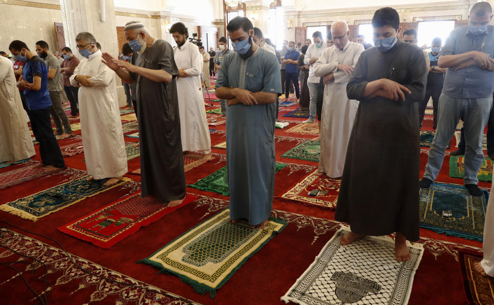 Palestinian worshippers wear protective face masks at the last Friday prayer of the holy fasting month of Ramadan, to prevent the spread of coronavirus pandemic, at al-Hasaynih beach mosque in Gaza City, Friday, May 22, 2020. Palestinian worshippers are filling Gaza's mosques as they open for the central Friday prayers after nearly two months of closure due to the coronavirus threat. (AP Photo/Adel Hana)