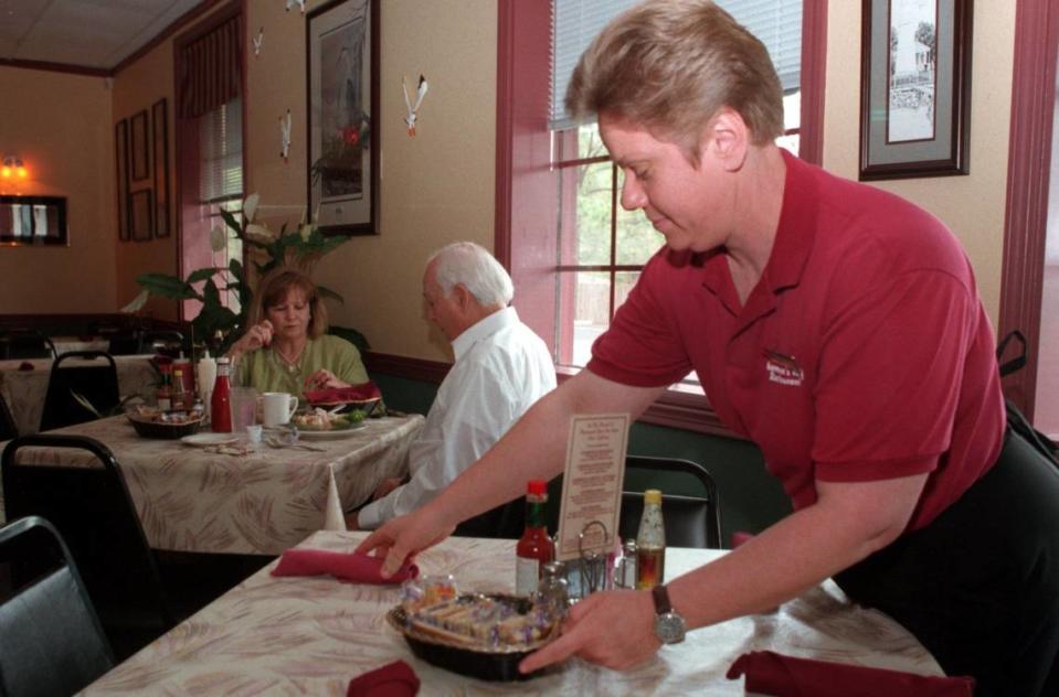 Sue Kostmayer of Biloxi arranges a table at Fisherman’s Wharf Restaurant in Ocean Springs in 1999. The orginal Fisherman’s Wharf was located on the beach in Biloxi near Casino row, but relocated to Ocean Springs after the casinos opened.