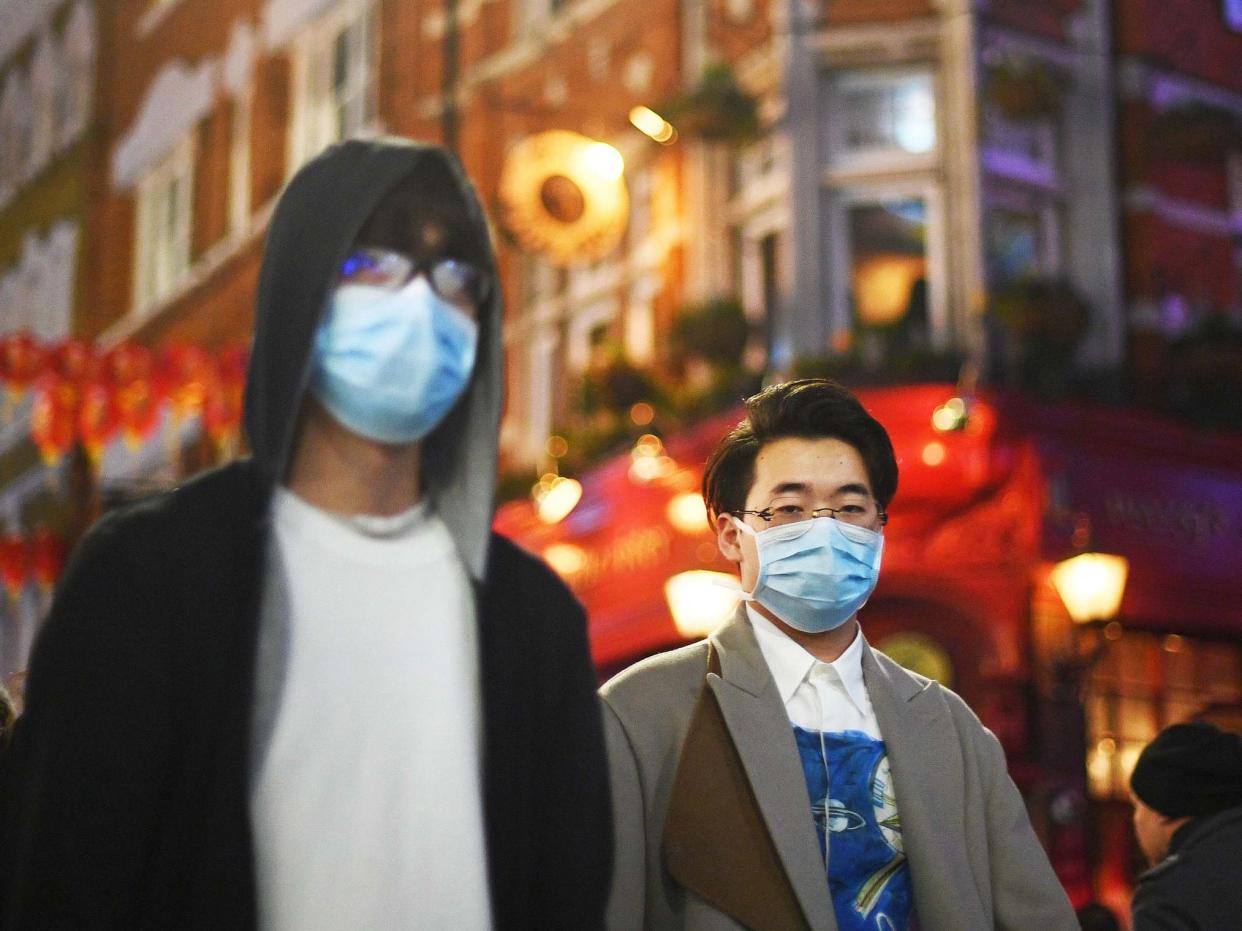 People wearing masks in China Town, London, as two people in the UK have tested positive for coronavirus: PA