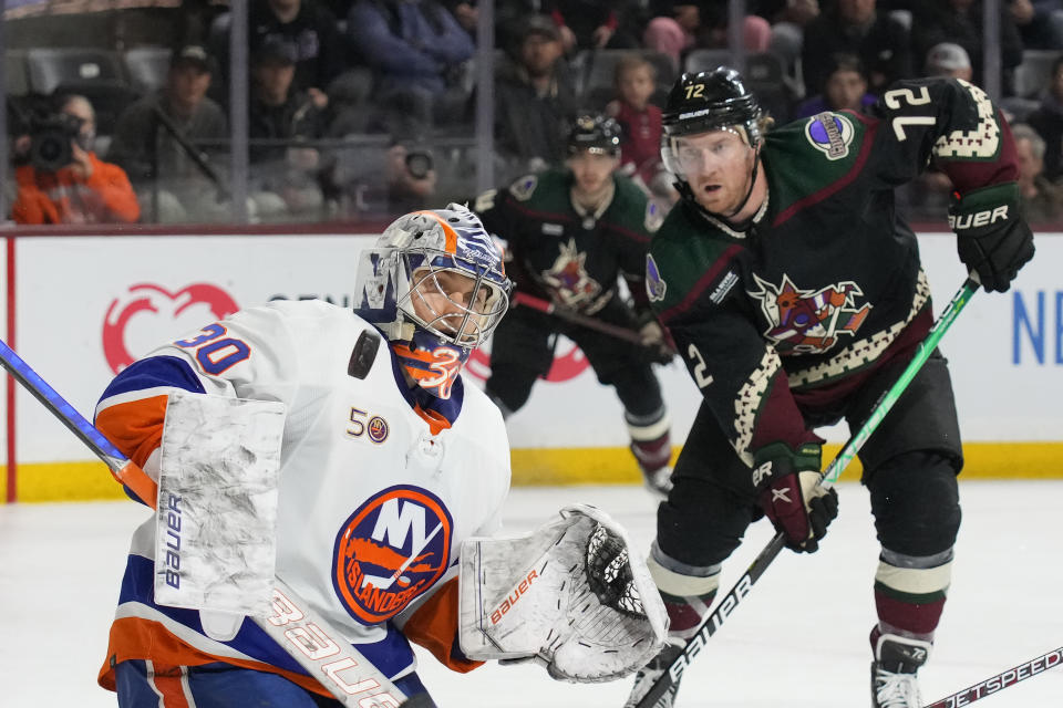 New York Islanders goaltender Ilya Sorokin (30) makes the save in front of Arizona Coyotes center Travis Boyd (72) in the third period during an NHL hockey game, Friday, Dec. 16, 2022, in Tempe, Ariz. Arizona won 5-4. (AP Photo/Rick Scuteri)