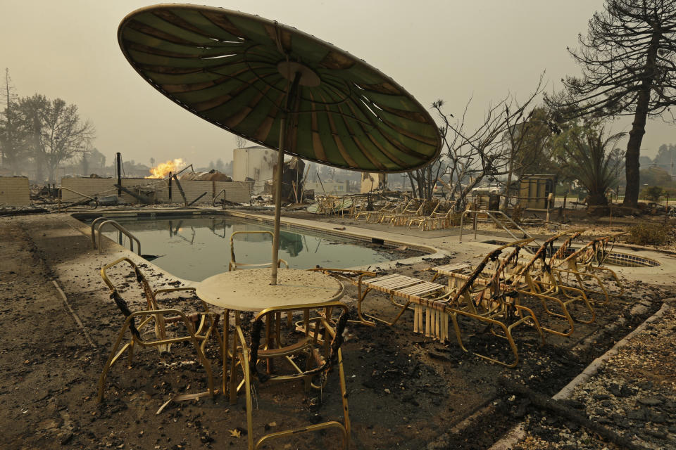 <p>Fire burns from an open gas valve near the pool area at the Journey’s End trailer park on Monday, Oct. 9, 2017, in Santa Rosa, Calif., after a wildfire destroyed nearly all of the roughly 160 units in the park for residents over age 55. The homes next to U.S. Highway 101 at the northern end of this city of 175,000 were among those that were consumed by flames as more than a dozen fires burned statewide. (Photo: Ben Margot/AP) </p>