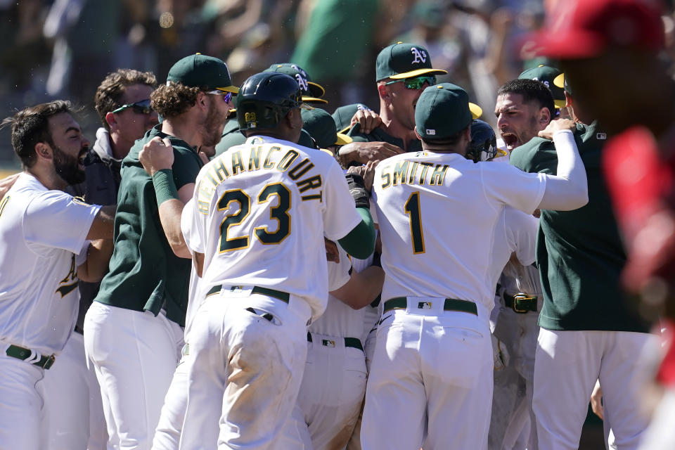 Oakland Athletics' Luis Barrera, right, is congratulated by teammates after hitting a three-run home run against the Los Angeles Angels during the ninth inning of the first baseball game of a doubleheader in Oakland, Calif., Saturday, May 14, 2022. (AP Photo/Jeff Chiu)