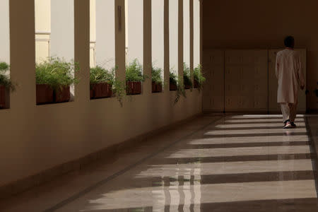 A monitor walks down a hallway at the Headstart private school in Islamabad, Pakistan, October 9, 2017. REUTERS/Caren Firouz