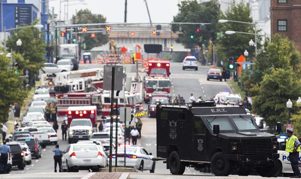 A Washington Police Emergency Response Team armored car (R) and other emergency vehicles fill M Street, Southeast, as they respond to a shooting at the Washington Navy Yard in Washington, September 16, 2013. Several people were killed and others were injured in the shooting at the Navy Yard in Washington D.C. on Monday. (REUTERS/Joshua Roberts)