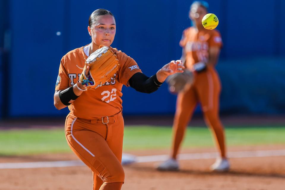 UT pitcher Estelle Czech (22) throws to first for an out against OSU in the first semifinal game between the teams Monday night.