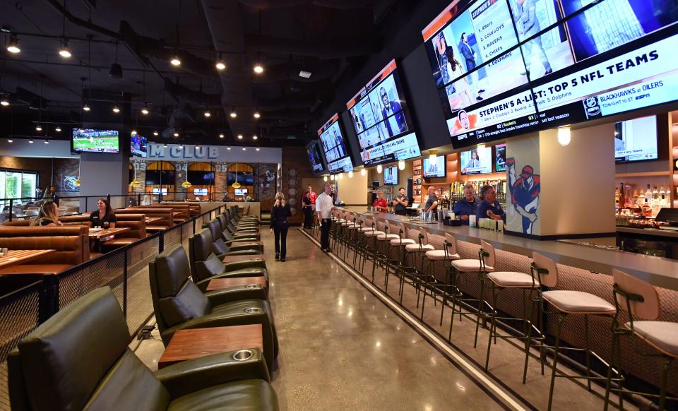 A long row of recliners offer the sports fan a perfect view of the many sports broadcasts at Allegiant Stadium sports bar and grill.