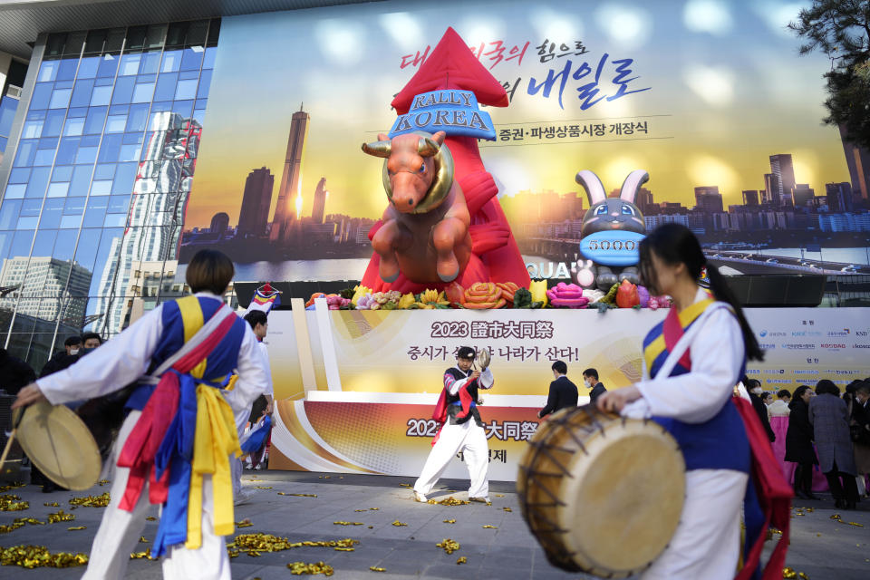 Dancers in traditional costumes perform to celebrate the opening for the Year 2023 trading outside of the Korea Exchange in Seoul, South Korea, Monday, Jan. 2, 2023. (AP Photo/Lee Jin-man)