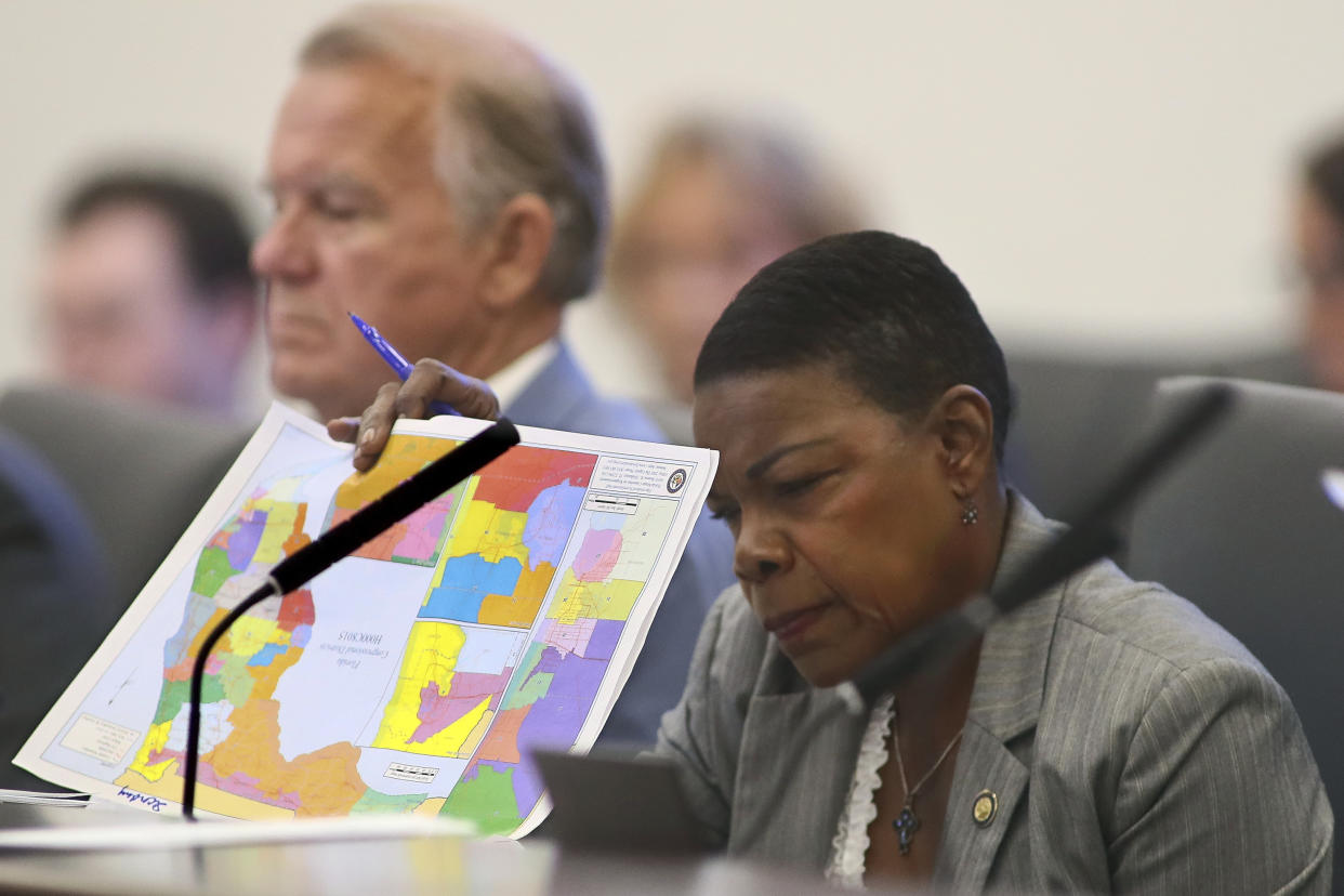 Sen. Audrey Gibson, D-Jacksonville, reviews proposed district maps during a Committee on Reapportionment meeting, Tuesday, April 19, 2022, at the Capitol in Tallahassee, Fla. The Florida special session to address new district lines starts today. (AP Photo/Phil Sears)