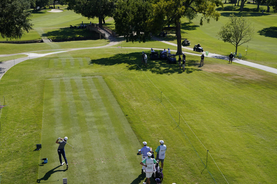 FILE - In this June 11, 2020 file photo, Jordan Spieth tees off on the 17th hole during the first round of the Charles Schwab Challenge golf tournament at the Colonial Country Club in Fort Worth, Texas. The PGA Tour went for most of nine months without fans and a year later is just now starting to get them back. (AP Photo/David J. Phillip, File)