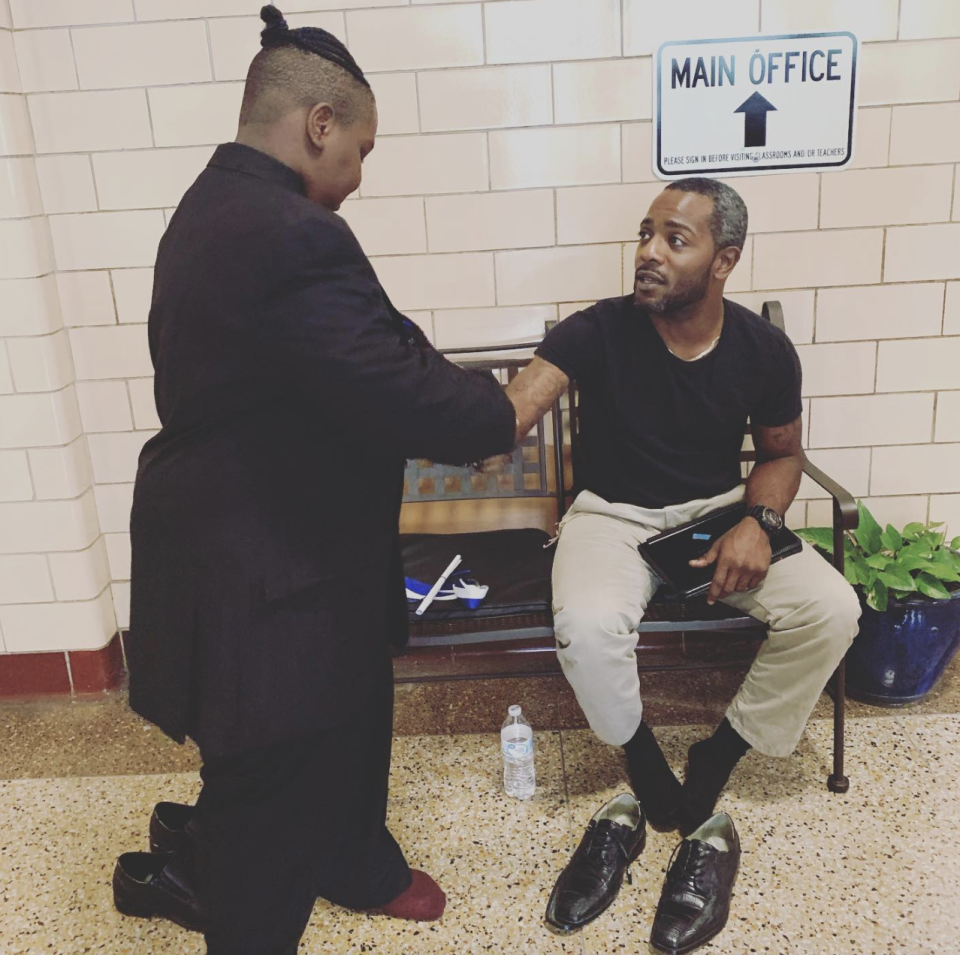 When a student broke his shoes right before graduation, Vohn Lewis, an elementary school teacher saved the day by giving the boy his own shoes. (Credit: Facebook/Bradley Cook Kopelove)