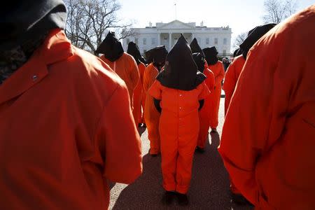 Protesters in orange jumpsuits from Amnesty International USA and other organizations rally outside the White House to demand the closure of the U.S. prison at Guantanamo Bay, in Washington January 11, 2016. REUTERS/Jonathan Ernst