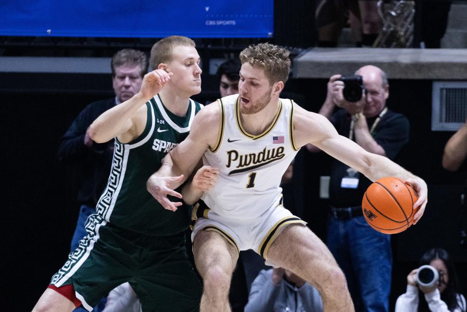 Jan 29, 2023; West Lafayette, Indiana, USA; Purdue Boilermakers forward Caleb Furst (1) dribbles the ball while Michigan State Spartans forward Joey Hauser (10) defends in the first half at Mackey Arena. Mandatory Credit: Trevor Ruszkowski-USA TODAY Sports
